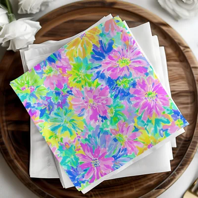 Napkins with a colorful floral pattern on a wooden tray.