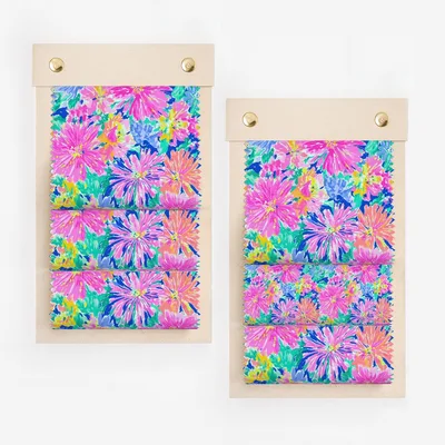 Two fabric swatches with bright pink and blue floral patterns.