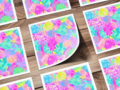 Colorful scallop shell pattern on square cards, some overlapping on a wooden surface.