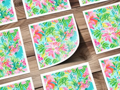 Floral pattern cards with pink flowers and teal leaves on a wooden surface.