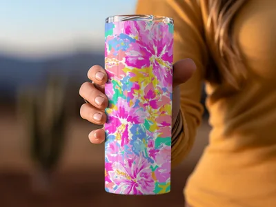 Tumbler with a colorful floral pattern of pink, blue, and yellow flowers.