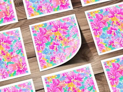 Several cards with colorful floral patterns are arranged on a wooden surface.