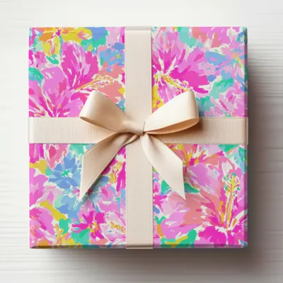 Gift box wrapped in floral paper with a cream ribbon and bow.