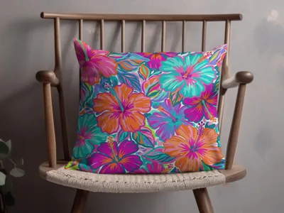 Throw pillow with a vibrant floral hibiscus pattern in pink, orange, and turquoise.