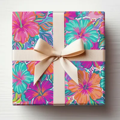 Gift box with floral wrapping paper and a cream ribbon bow.
