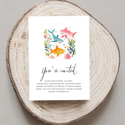 Invitation with sharks, fish, and flowers. "You're invited" text prominent.