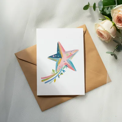 Card with colorful starburst design on brown envelope and roses.