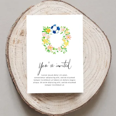 Floral soccer wreath invitation with "You're invited" text.