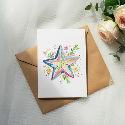 Card with a colorful watercolor star design on a brown envelope.