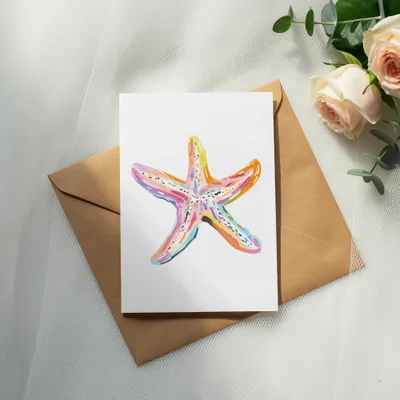 Watercolor starfish illustration on a card with roses and eucalyptus.