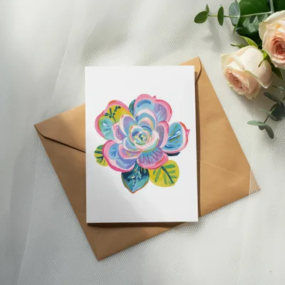 Greeting card with a colorful succulent illustration on a brown envelope.