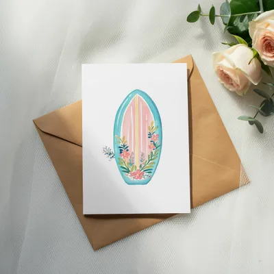 White card with floral surfboard design on brown envelope, light pink roses.