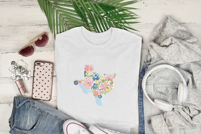 White t-shirt with colorful floral Texas outline graphic.