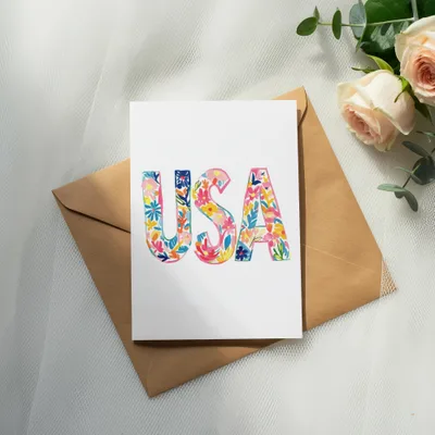 Card with "USA" in floral letters on a brown envelope.