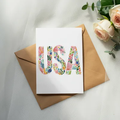 Card with "USA" in colorful floral letters on an envelope.