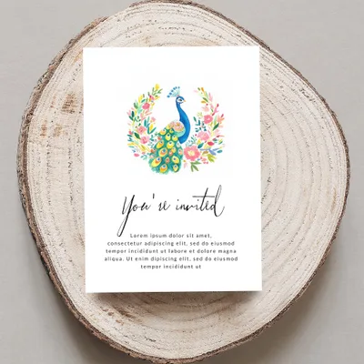 Invitation card with peacock wreath and "You're invited" text.