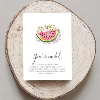 Invitation with watercolor watermelon slice and floral accents, text "You're invited".