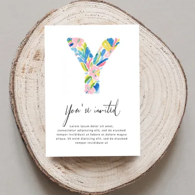 Invitation card with colorful watercolor "Y" and "You're invited" text.
