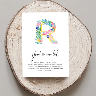 Invitation with a floral letter "R" and placeholder text.