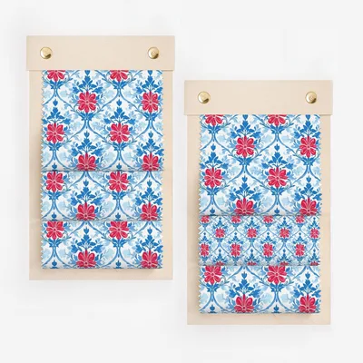 Two fabric swatches with red floral pattern on blue background.