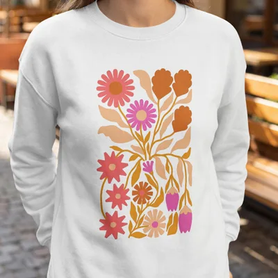 White sweatshirt with a colorful floral illustration featuring pink and orange flowers.