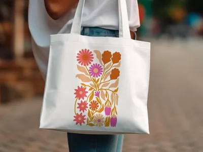 White tote bag with a colorful floral pattern in pink, orange, and yellow.