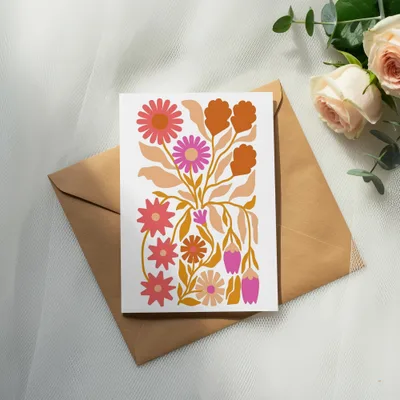 White card with colorful floral illustration on a brown envelope.