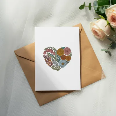 Blank card with a floral heart design on an open envelope.