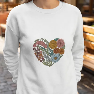 White sweatshirt with a heart-shaped floral design.