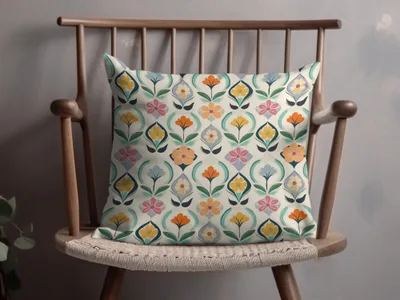 Throw pillow with a colorful floral geometric pattern on a wooden chair.