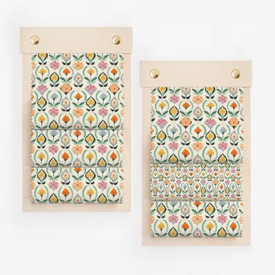 Fabric swatches on a wooden hanger with floral pattern.