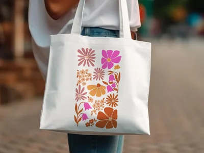 White tote bag with a colorful floral pattern in pink and orange.