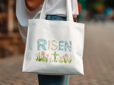 White tote bag with "RISEN" text and Easter floral design.
