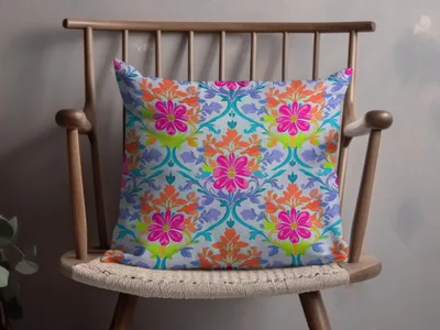 Decorative throw pillow with a vibrant floral pattern on a wooden chair.
