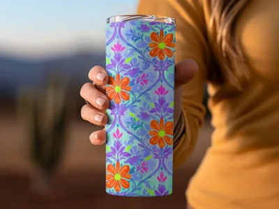 Purple and blue floral pattern on a tumbler held by a hand.
