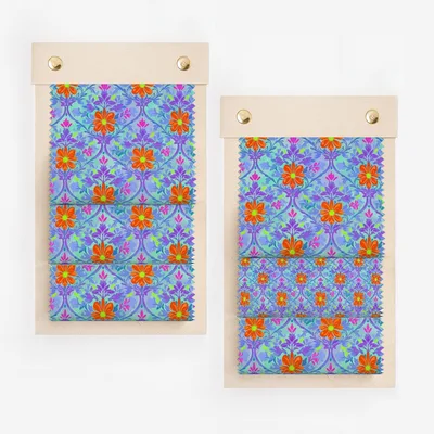 Fabric swatches with purple, orange, and blue floral pattern on light wood backing.