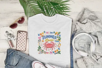 White t-shirt with crab and "Summer Lovin'" text, styled with sunglasses, jeans, and headphones.