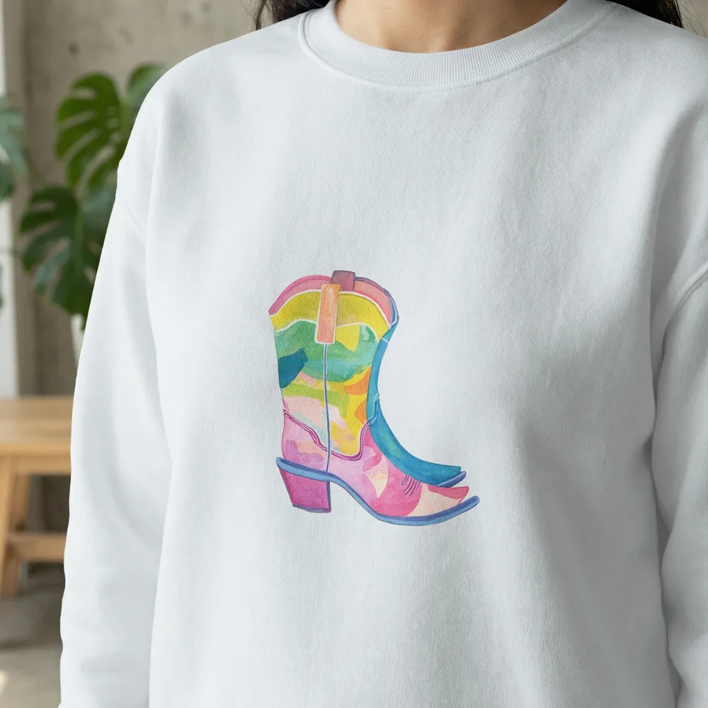 White sweatshirt with a colorful watercolor cowboy boot graphic.