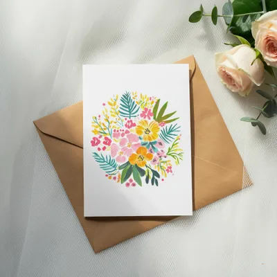 Floral bouquet illustration on a card resting on a brown envelope.