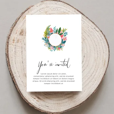 Invitation card with floral wreath and "You're invited" text.