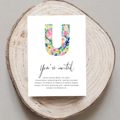 "You're invited" card with large floral letter U and placeholder text.