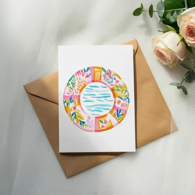 Watercolor illustration of a swimming pool on a card, on a brown envelope.