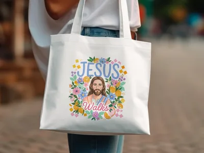 Jesus Walks text with floral and citrus fruit illustration on white tote bag.