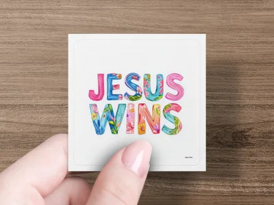 Jesus Wins text with floral watercolor design.