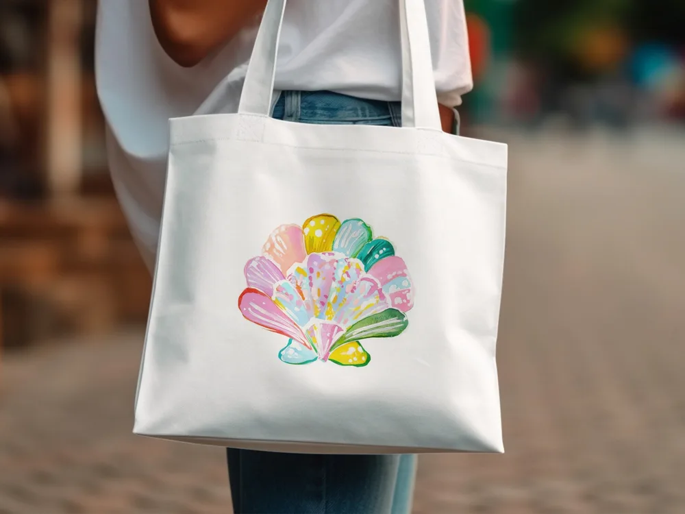 White tote bag with colorful seashell illustration.