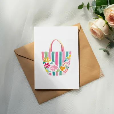Watercolor illustration of a striped tote bag with flowers on a card.