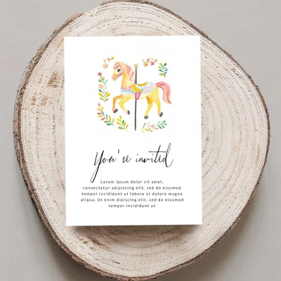 Carousel horse invitation with floral accents and placeholder text.