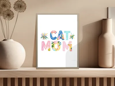 Colorful "CAT MOM" text with floral accents in a framed print.