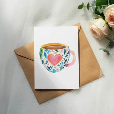 White card with colorful floral mug illustration on a brown envelope.
