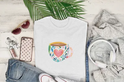 White t-shirt with a watercolor coffee mug design featuring a heart.